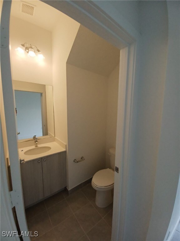 bathroom with tile patterned floors, toilet, and vanity