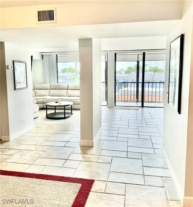 interior space featuring a textured ceiling and light tile patterned floors