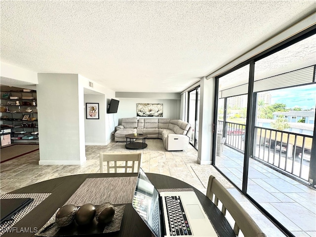 living room with a textured ceiling and light tile patterned flooring