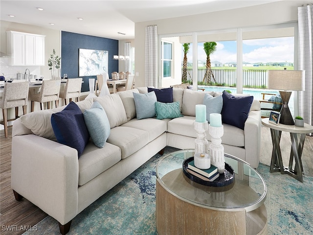 living room with hardwood / wood-style floors and an inviting chandelier