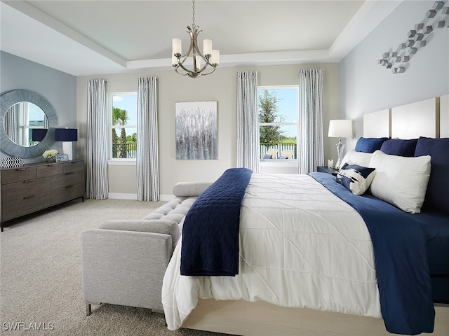 bedroom featuring light colored carpet, an inviting chandelier, and a raised ceiling