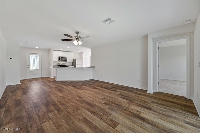 unfurnished living room featuring ceiling fan and wood-type flooring