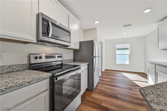 kitchen with stainless steel appliances, white cabinetry, dark hardwood / wood-style floors, and light stone counters