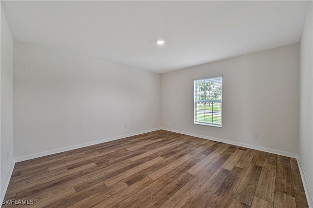 unfurnished room with hardwood / wood-style floors