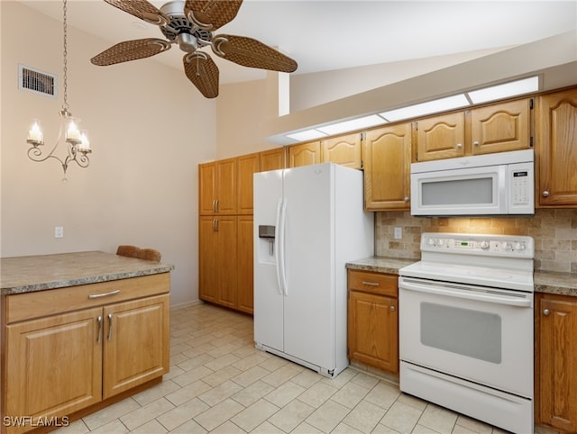 kitchen featuring lofted ceiling, white appliances, decorative light fixtures, ceiling fan with notable chandelier, and decorative backsplash