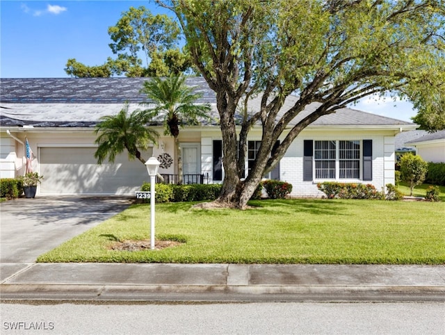 ranch-style home with a front yard and a garage