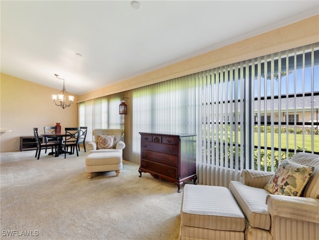 sitting room featuring carpet floors and an inviting chandelier