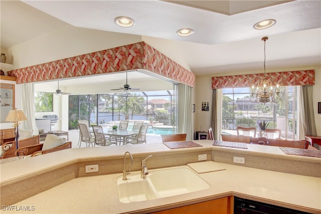 kitchen featuring sink, dishwasher, ceiling fan with notable chandelier, and hanging light fixtures