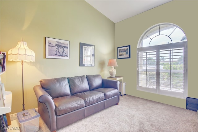 living room featuring carpet flooring and vaulted ceiling