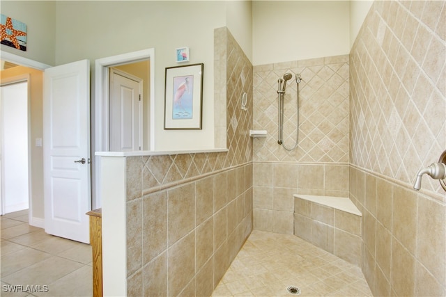 bathroom with tile patterned floors and a tile shower