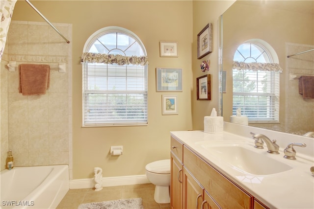 full bathroom with tile patterned flooring, toilet, tiled shower / bath, and vanity