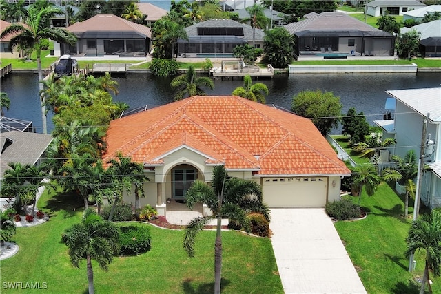 view of front of house with a garage, a front lawn, a lanai, and a water view