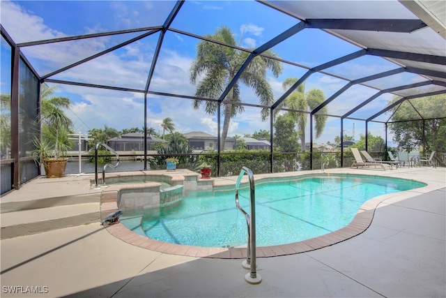 view of swimming pool with glass enclosure, a patio, and an in ground hot tub