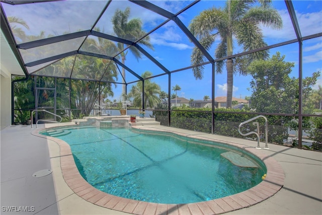 view of swimming pool featuring glass enclosure, a patio area, and an in ground hot tub