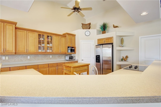 kitchen with ceiling fan, high vaulted ceiling, stainless steel appliances, and tasteful backsplash