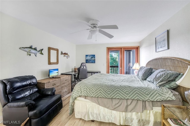 bedroom with access to exterior, a ceiling fan, french doors, and wood finished floors