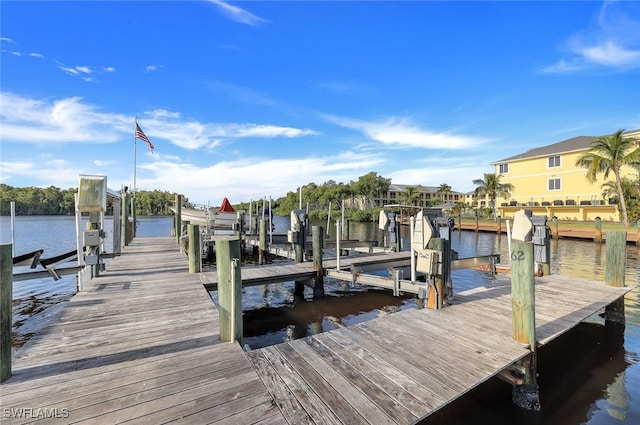 dock area with a water view and boat lift