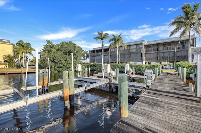 dock area with a water view and boat lift