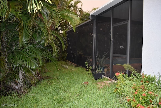 yard at dusk with a sunroom