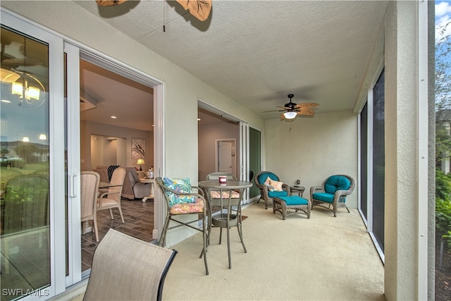 sunroom featuring ceiling fan