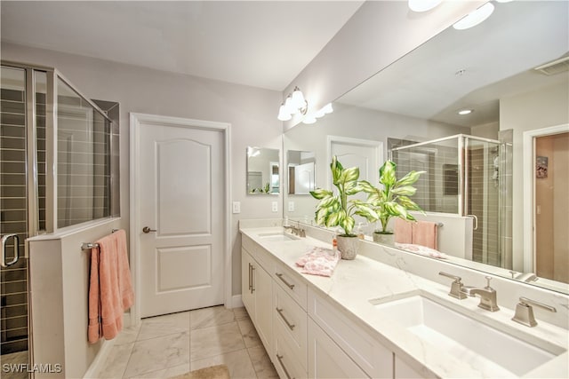 bathroom featuring a shower with door and vanity