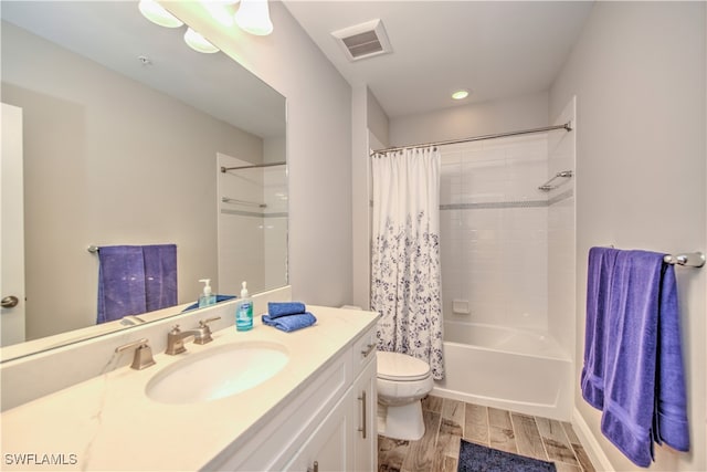 full bathroom with vanity, wood-type flooring, toilet, and shower / tub combo