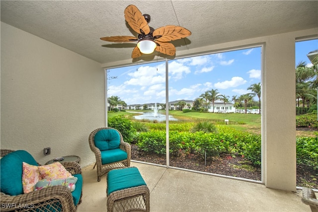 unfurnished sunroom with a healthy amount of sunlight and ceiling fan