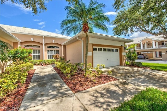 8658 Patty Berg Ct, Fort Myers, FL 34275 - view of front of property with a garage, driveway, and stucco siding