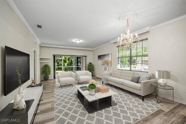 living area with light wood-style floors, a healthy amount of sunlight, and crown molding