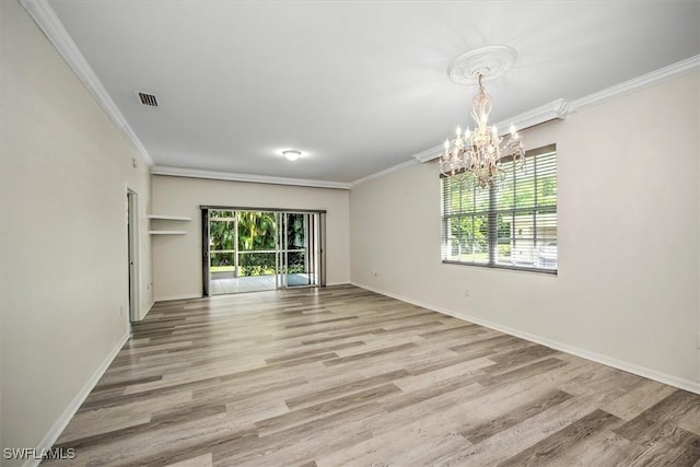 empty room featuring crown molding, light wood-style flooring, and baseboards