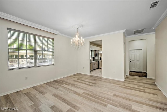 empty room featuring visible vents, crown molding, a notable chandelier, and light wood finished floors