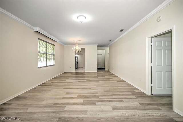 empty room featuring an inviting chandelier, light hardwood / wood-style flooring, and ornamental molding