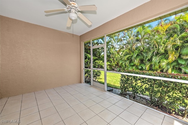 unfurnished sunroom featuring ceiling fan