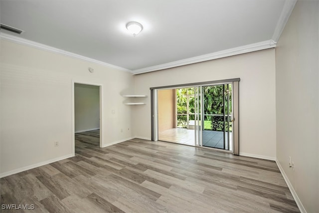 empty room with crown molding and wood-type flooring