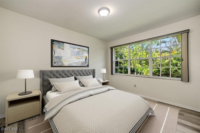 bedroom featuring light wood-type flooring and baseboards