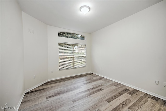 spare room with wood-type flooring