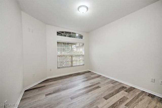 empty room featuring light wood-style floors and baseboards