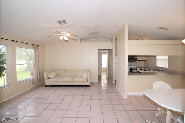 unfurnished living room featuring lofted ceiling, light tile patterned flooring, and ceiling fan