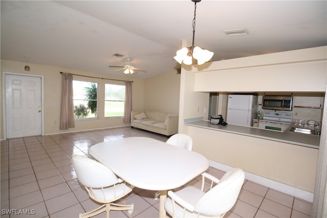 dining room featuring sink, light tile patterned floors, and ceiling fan with notable chandelier