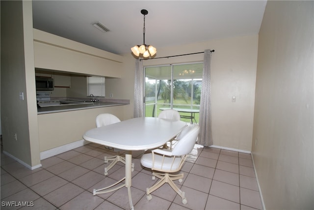 dining area with a notable chandelier and light tile patterned flooring