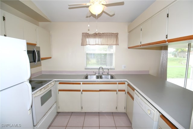 kitchen with sink, white cabinetry, white appliances, and light tile patterned flooring