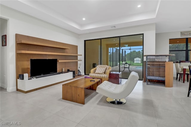 tiled living room with a tray ceiling