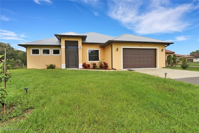 view of front of property with a garage and a front lawn