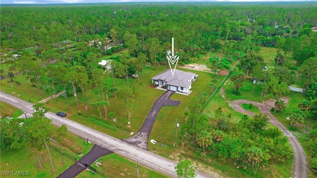 3660 4th Ave NE, Naples, FL 34120 - birds eye view of property with a wooded view