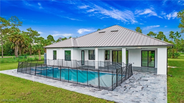 view of pool with a patio area and a lawn