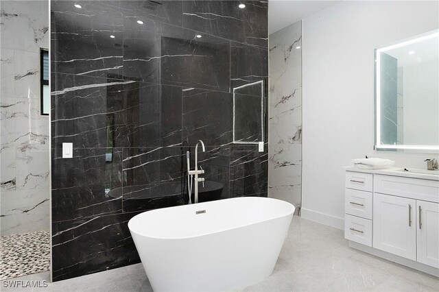 bathroom featuring tile walls, independent shower and bath, tile patterned floors, and vanity