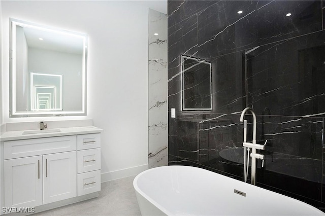 3660 4th Ave NE, Naples, FL 34120 - bathroom featuring baseboards, marble finish floor, vanity, and a freestanding bath