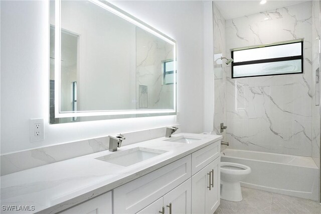 full bathroom featuring tile patterned flooring, toilet, vanity, and tiled shower / bath