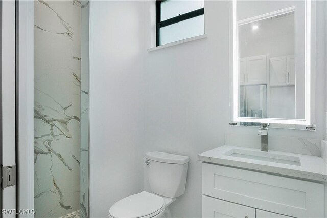 3660 4th Ave NE, Naples, FL 34120 - full bath featuring toilet, vanity, and a marble finish shower