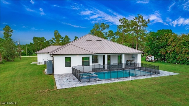3660 4th Ave NE, Naples, FL 34120 - rear view of house with stucco siding, metal roof, a yard, and an outdoor pool